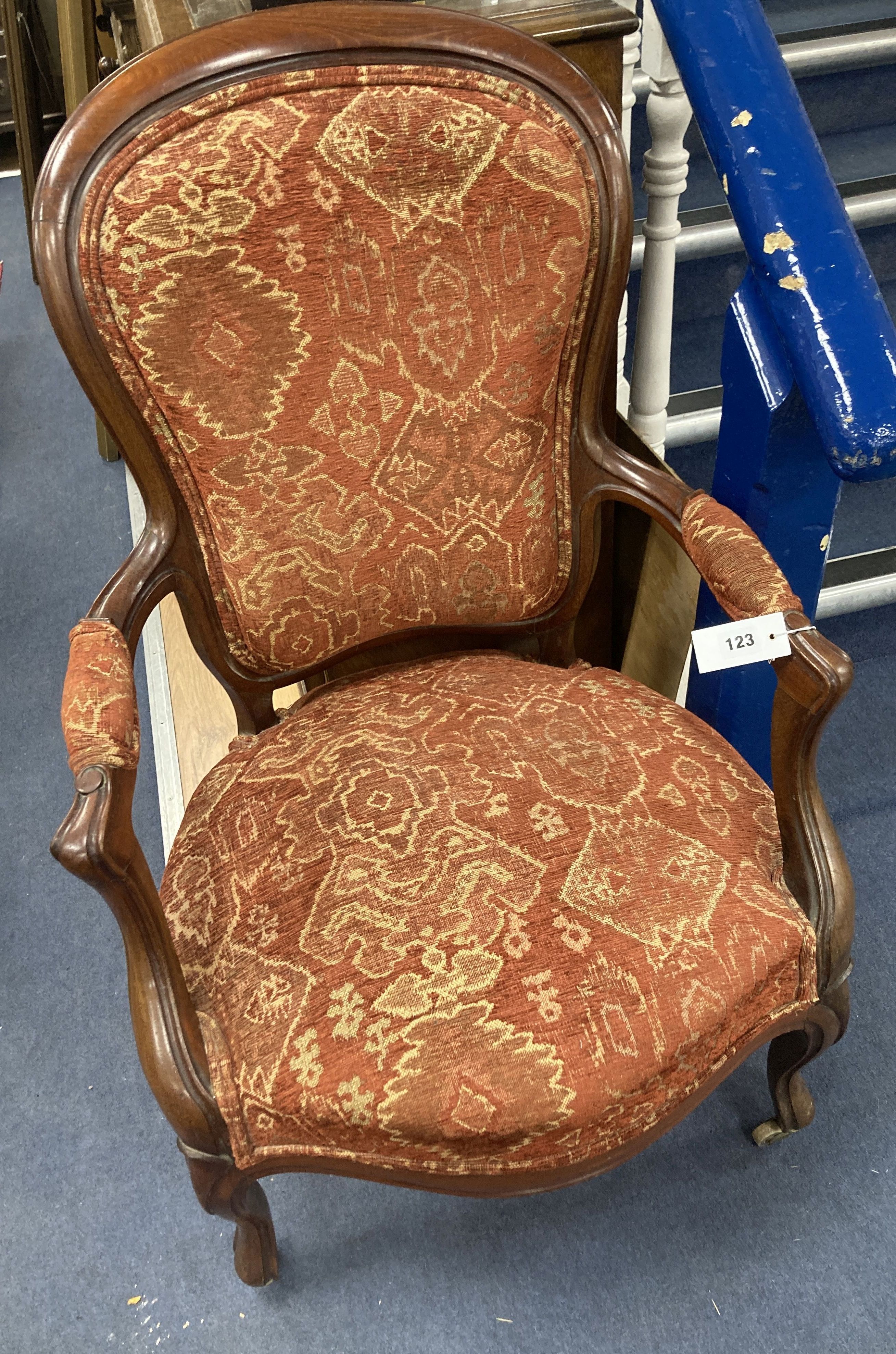 A Victorian mahogany upholstered spoon back upholstered elbow chair, 95cm high, width 63cm